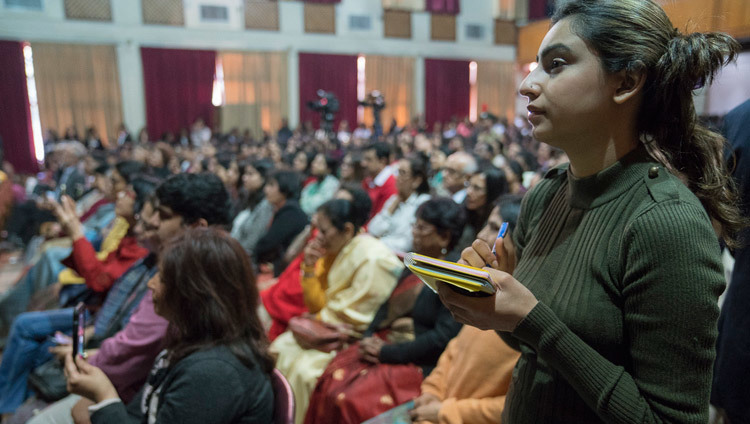 Студентка записывает ответ Его Святейшества Далай-ламы на ее вопрос во время лекции в Колледже Иисуса и Марии.  Фото: Тензин Чойджор (офис ЕСДЛ)