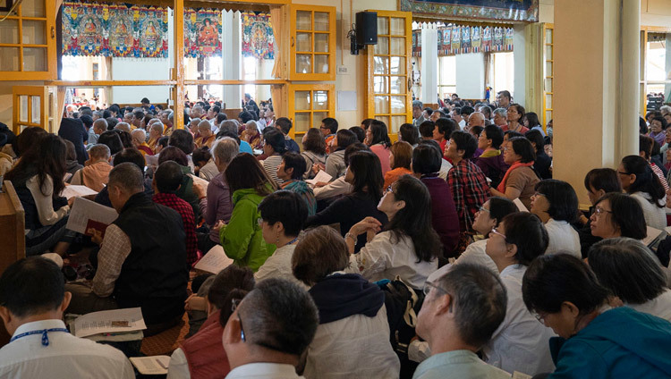 Верующие следят за текстом во время заключительного дня учений Его Святейшества Далай-ламы, организованных в главном тибетском храме по просьбе тайваньских буддистов. Фото: дост. Тензин Джампхел.
